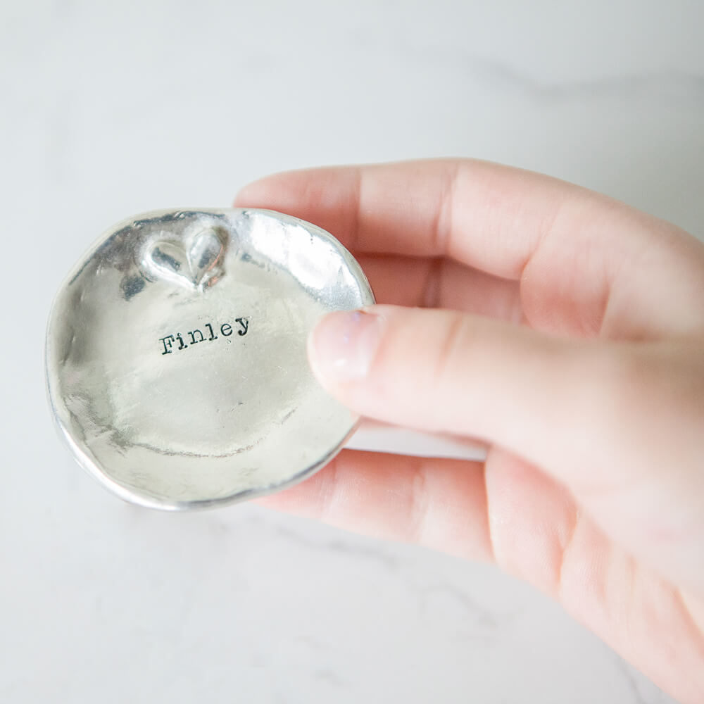 Little Girl holding a personalized trinket dish for her jewelry.