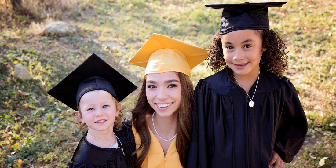 Three girls graduating from kindergarten, elementary school, and high school.